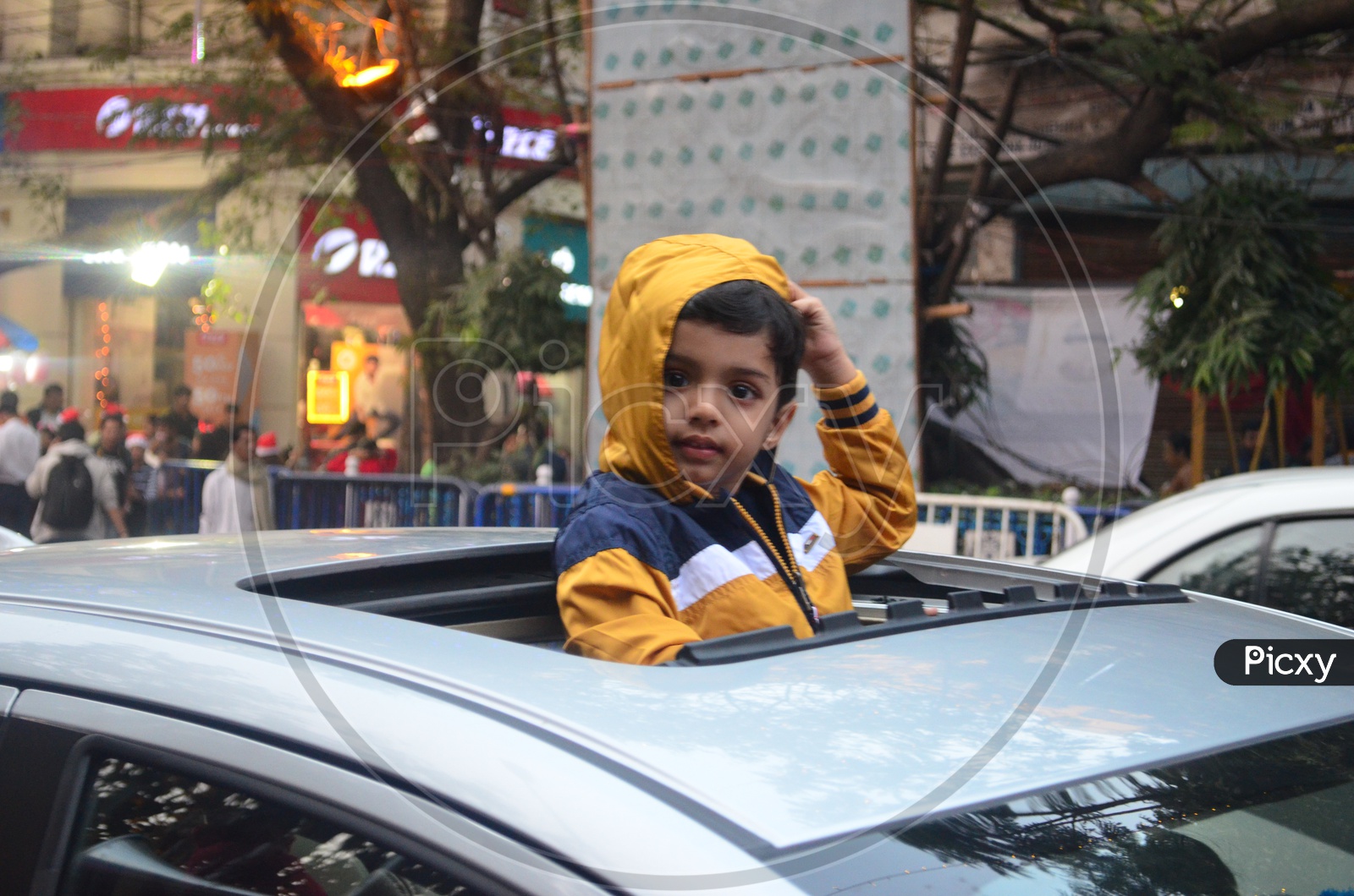 An Indian Boy  Looking Out From  Car Rear Window