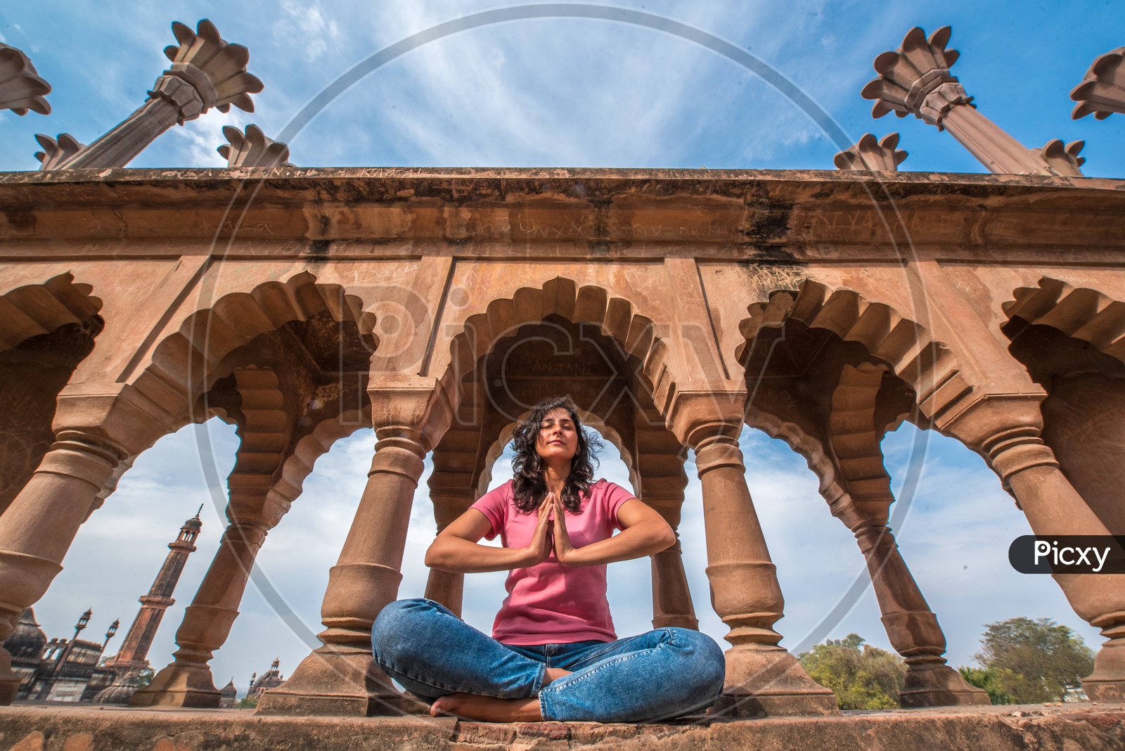 A Young Woman Practising Meditation On a Heritage Site