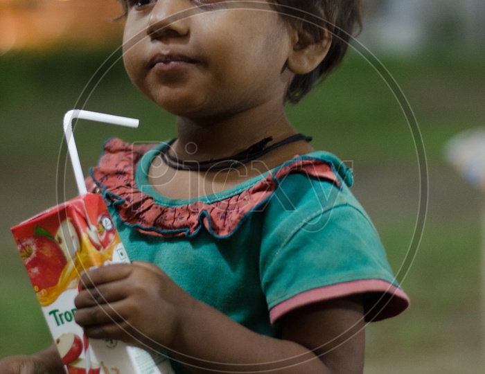 Young Indian Girl Child Drinking Packaged Juice
