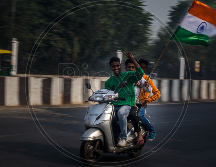 Young Indian Man Carrying And Waving Indian National Flag