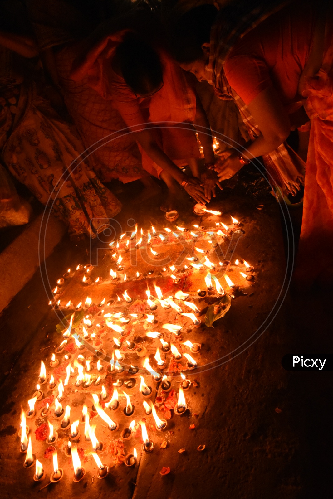 Indian Hindu  Devotees Lighting  Dias  On Festival Eve At Temple Premise