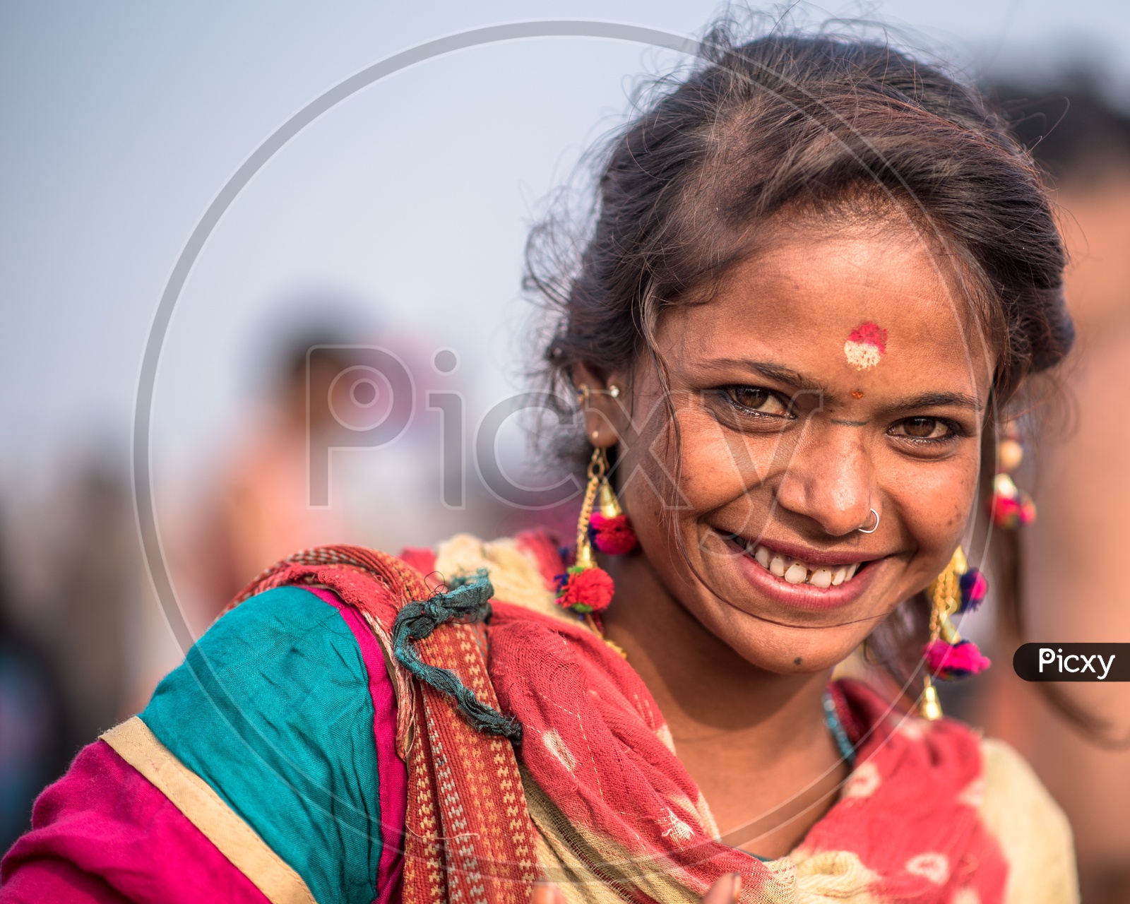 A Young Girl Or Woman Vendor  With a Smiling Face In Kumbh Mela