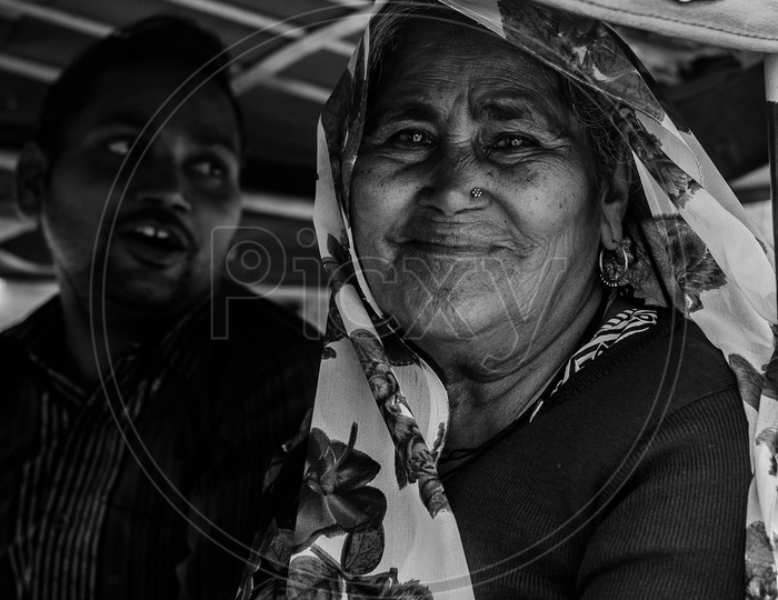 Portrait Of a Happy Indian Old Woman Sitting in a Commuting Vehicle
