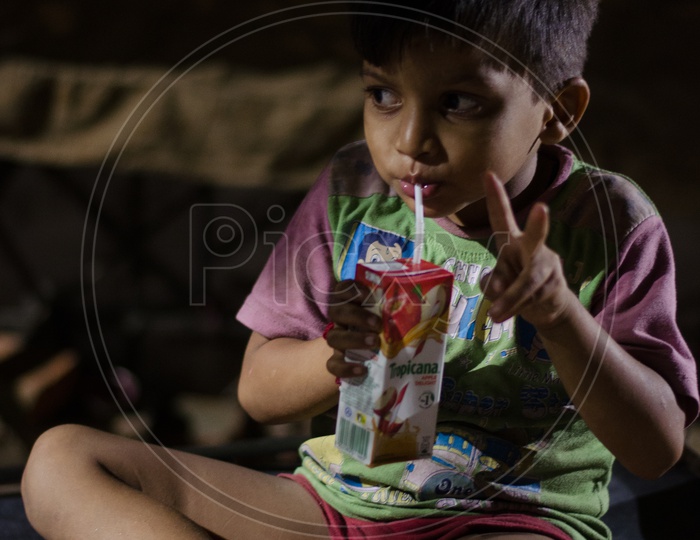 Young Indian Boy  Child Drinking Packaged Juice