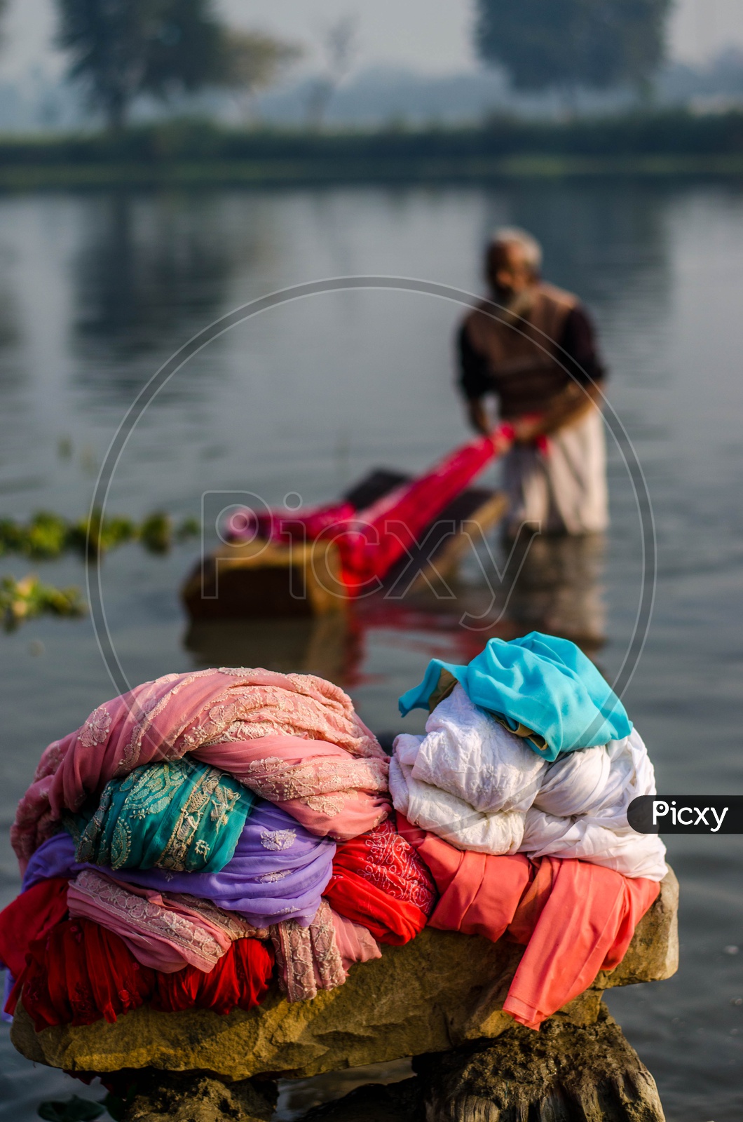 Washed Clothes Pile By a Clothes Washer Or Dhobi  on Bank Of a Lake