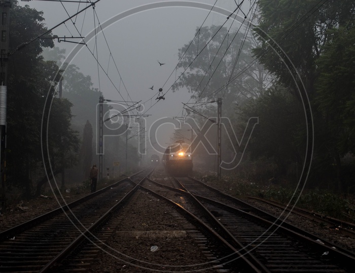 Indian train On a Track At Morning Mist