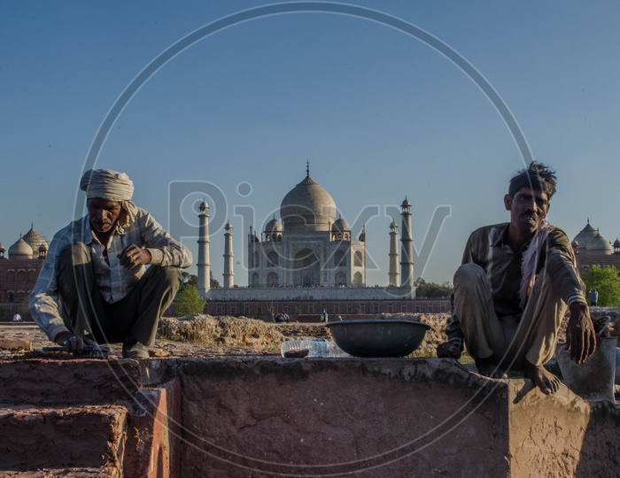 Construction Workers  Sitting At  Taj Mahal