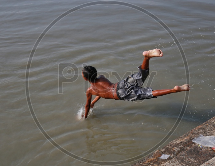 Boy jumping into the Brahmaputra river