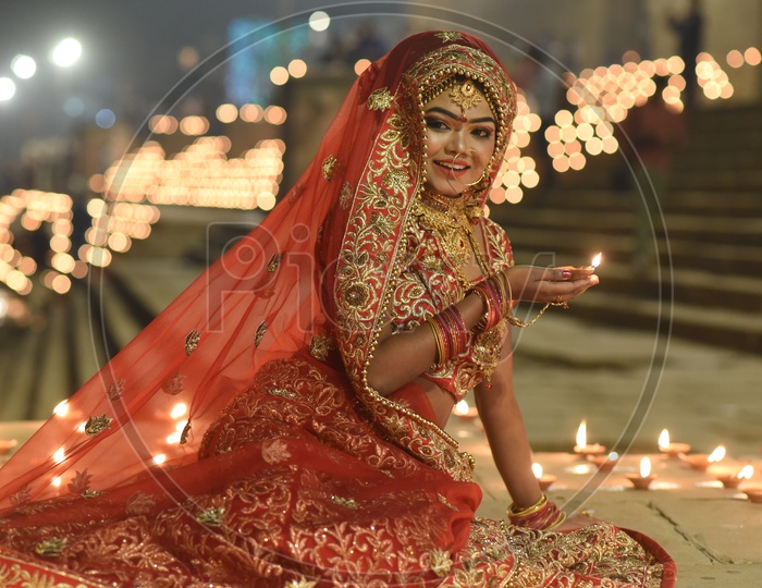A Traditional Indian Woman  In Elegant Look With Diwali Dias