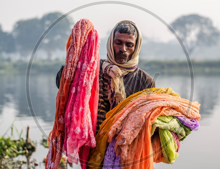 Clothes Washer Or Dhobi Washing Clothes In a Lake