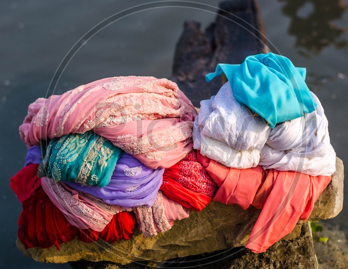 Washed Clothes Pile By a Clothes Washer Or Dhobi  on Bank Of a Lake