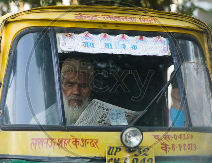 A Auto Driver Reading Newspaper
