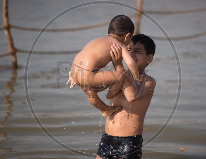 Children Bathing In River  At Kumbh Mela.  Brother's love.