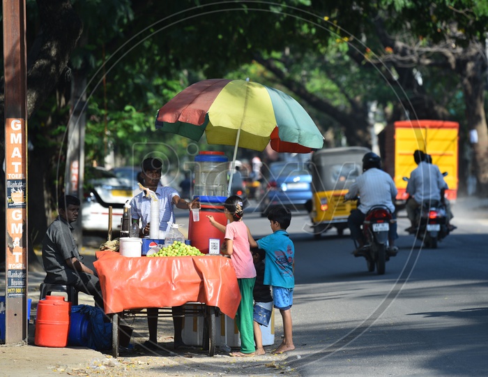 Children Drinking  Lemon Soda To Beat The Summer Heat From a Road Side Vendor