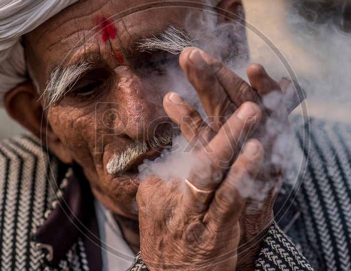 An Indian Old Man  Smoking  Ganja Or marijuanas  or weed