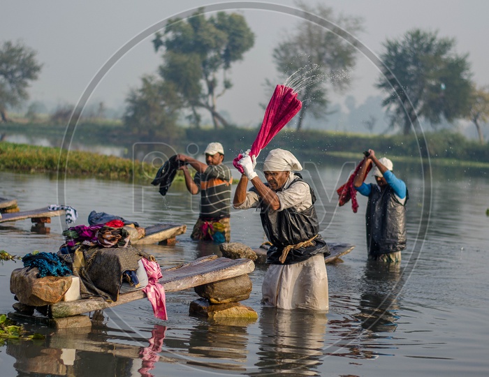 Cloth Washers Or Dhobi  Washing Clothes On a Lake Water in Rural Areas