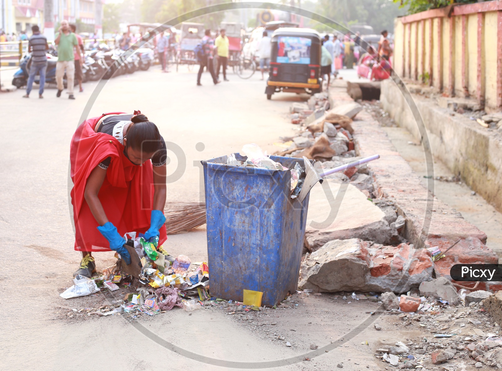A woman sweeping garbage in Guwahati city.