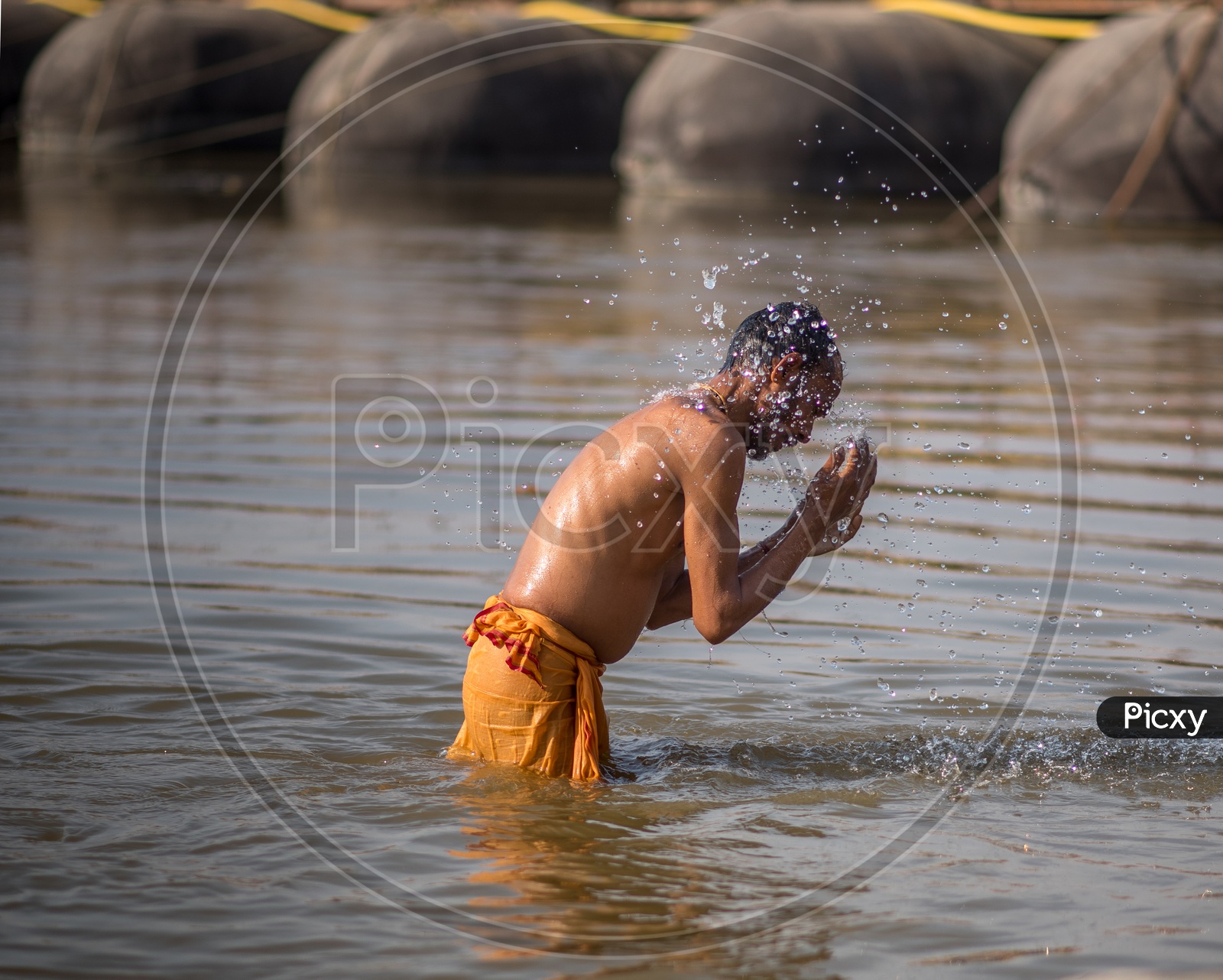 Indian Sadhu or Baba Taking Bath In Holi River At Kumbh Mela