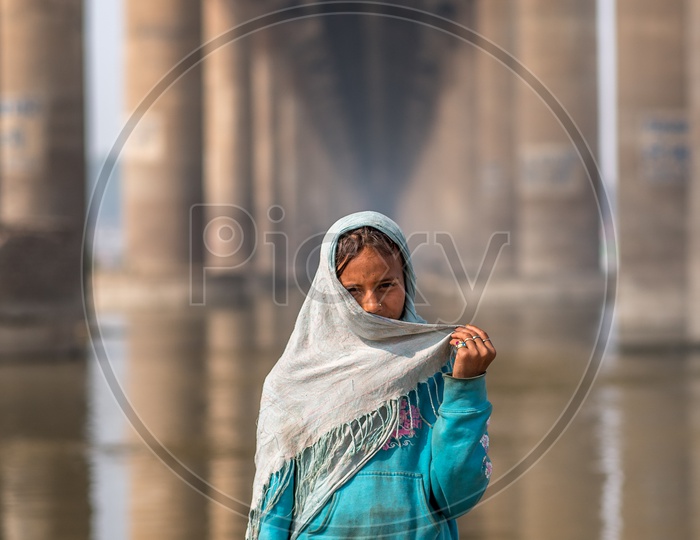 A Young Indian Girl Portrait At a Water Bridge