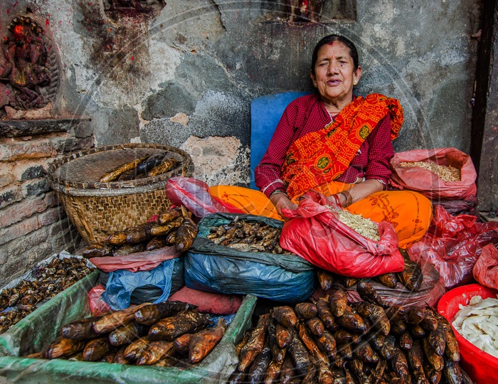 A Woman Vendor Selling Dry Fish On Streets