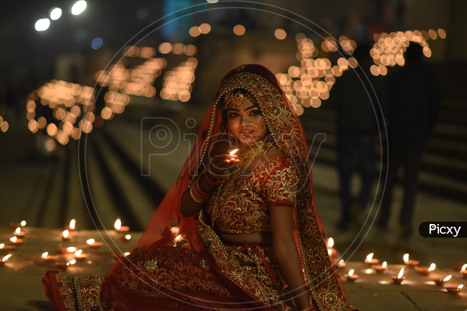 A Traditional Indian Woman  In Elegant Look With Diwali Dias