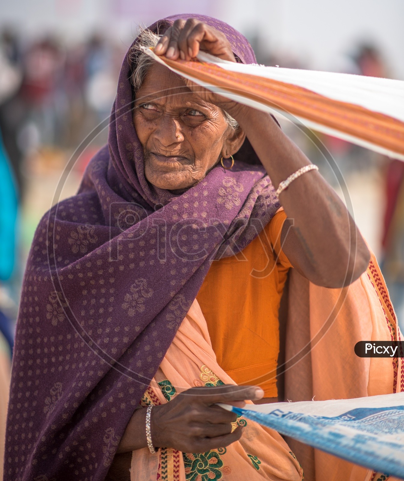 An Old Woman On Drying Her Saree In Open Air