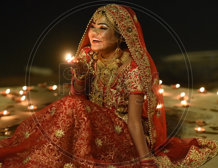 A Traditional Indian Woman  In Elegant Look With Diwali Dias  and Posing