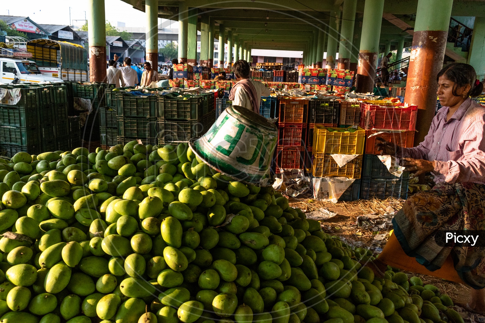 Image of Farmers unloading the mangoes stock at Kothapet fruit market