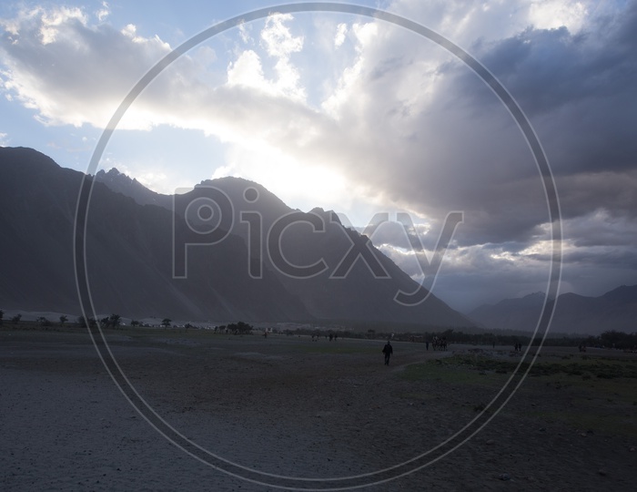 Camel Rides In the River Valleys Of Nubra With Mountain Ranges In Background