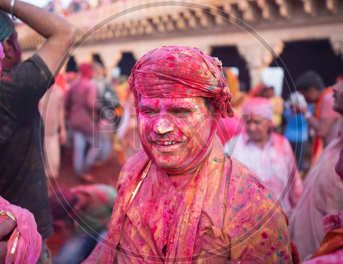 A local man covered with festive Holi colors
