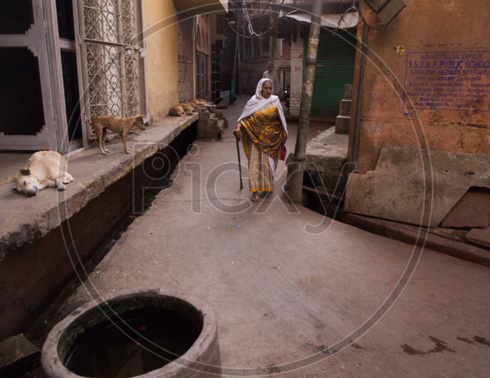 An old woman walking in the streets of Barsana