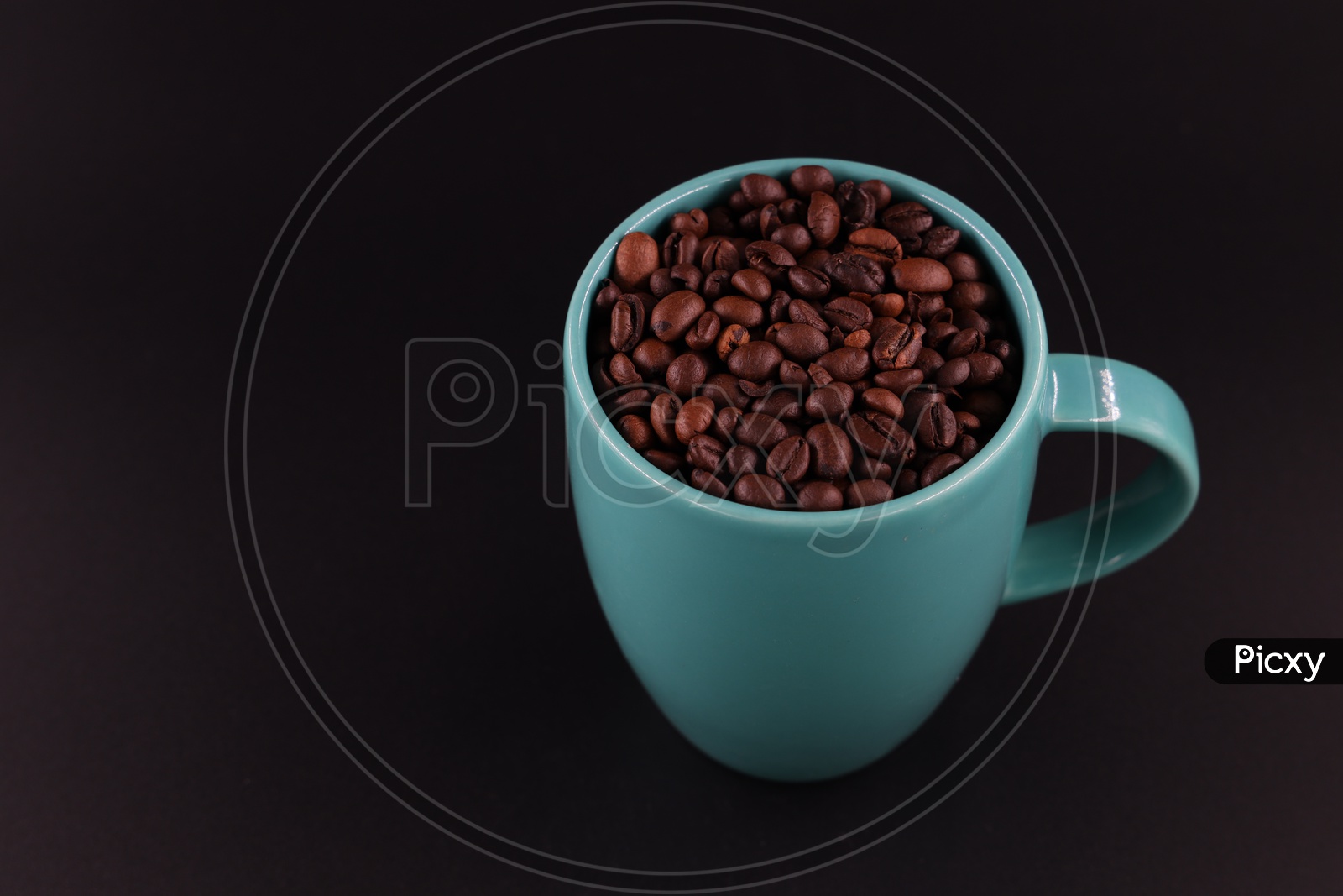 Coffee Beans In a Coffee Mug Composition On an Isolated Black Background