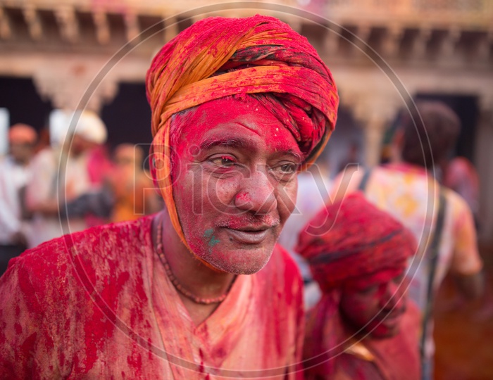 A man's face covered with Holi colors