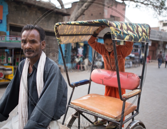 A Young Boy In Rickshaw  On the Streets Of Barsana
