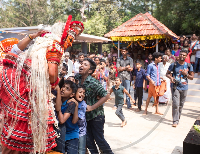 Kids alongside the Performer during Muchilottu Bhagavathi Theyyam