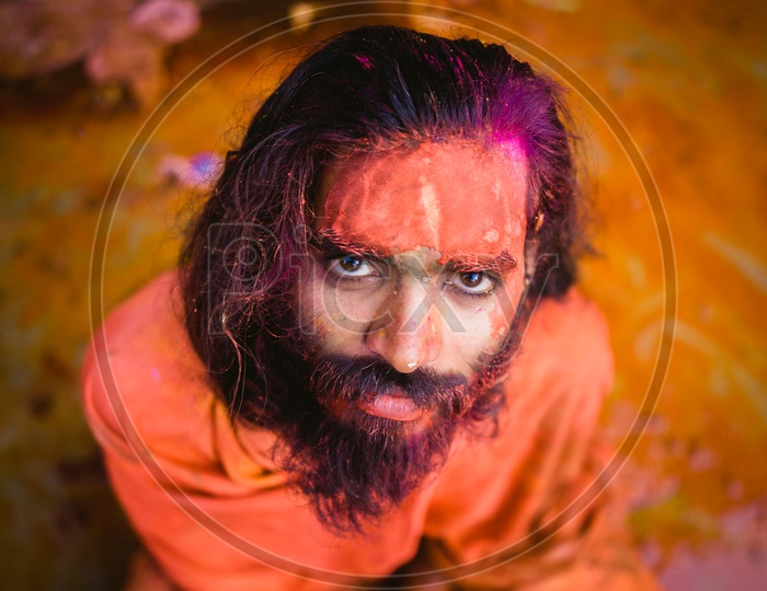 Man's face covered with holi colors