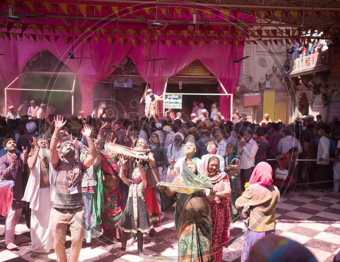 People Celebrating  Holi In Sri Radha Rani Temple Premise With Color Spalsh