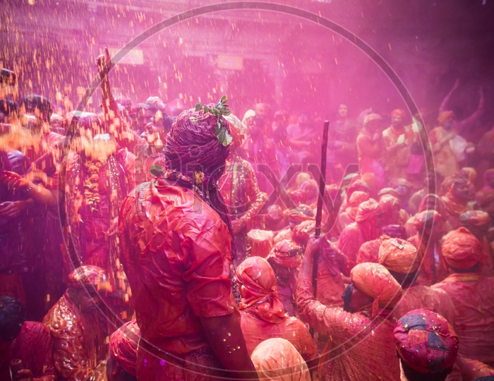 Local People In Barsana Celebrating Lathmar Holi as a Crowd Singing Songs And  Siting  With Color And Water Spalsh on them