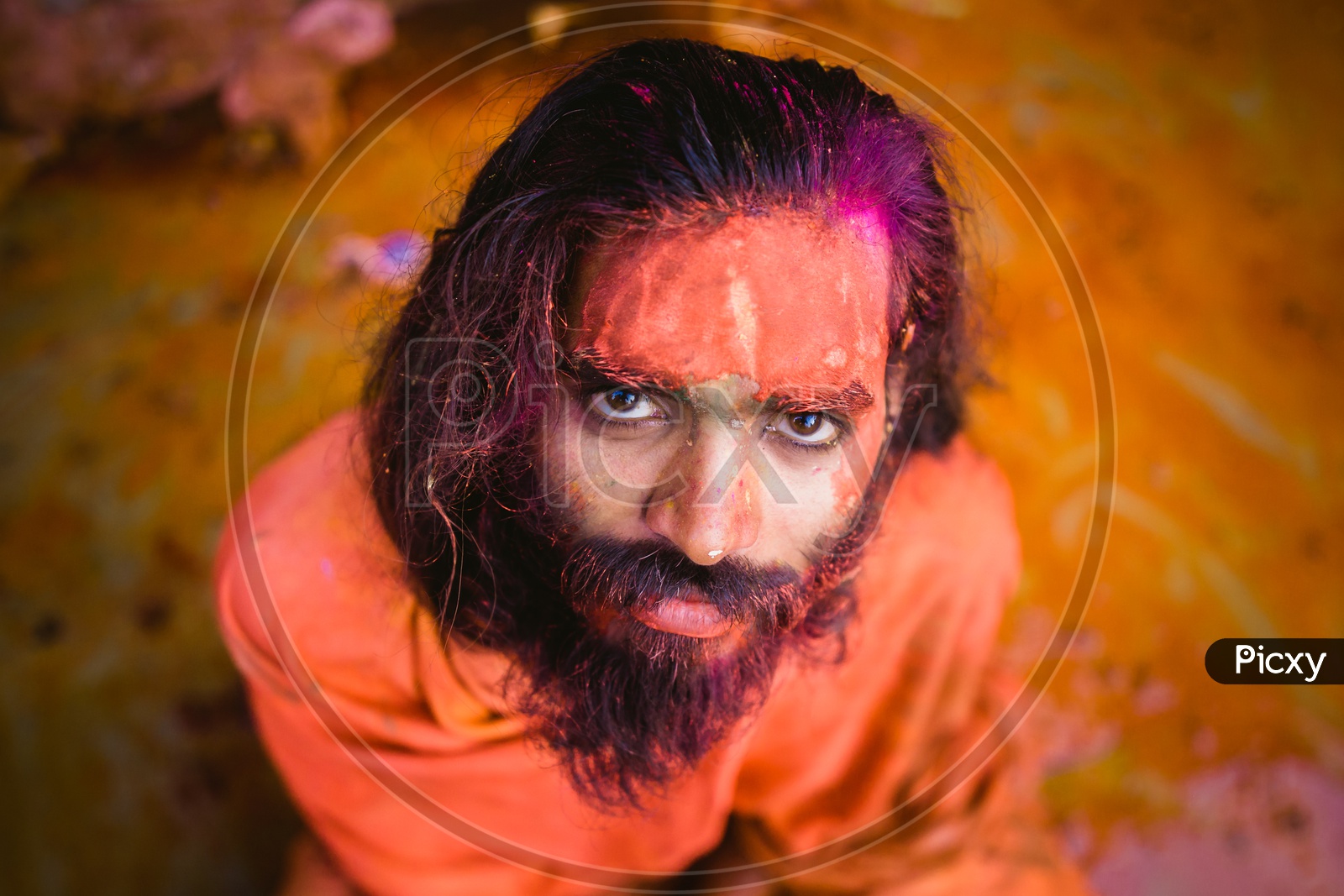 Man's face covered with holi colors