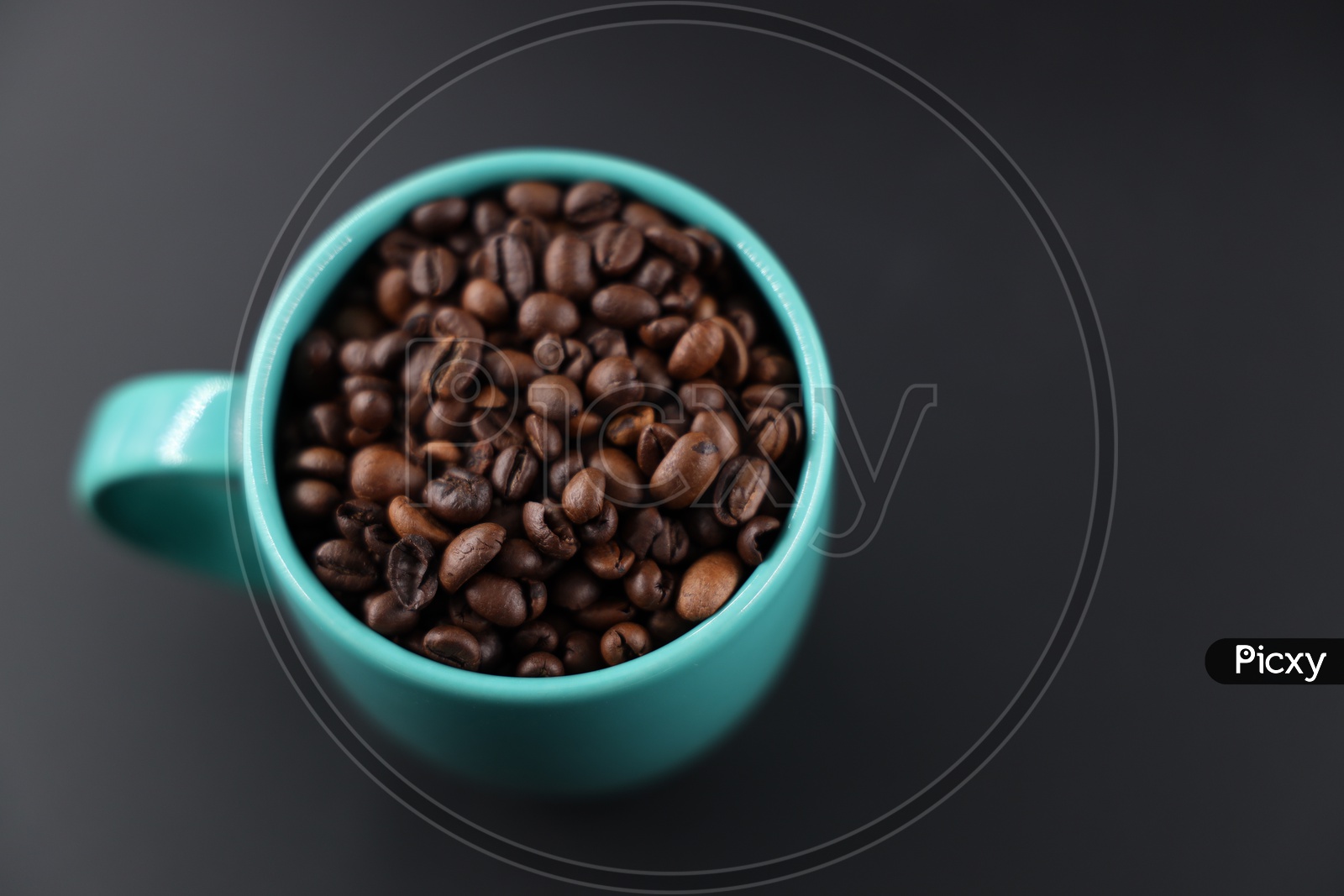 Coffee Beans In a Coffee Mug Composition On an Isolated Black Background