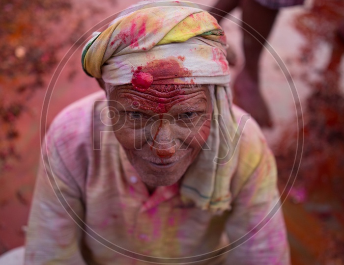 Old man's face covered with Holi colors