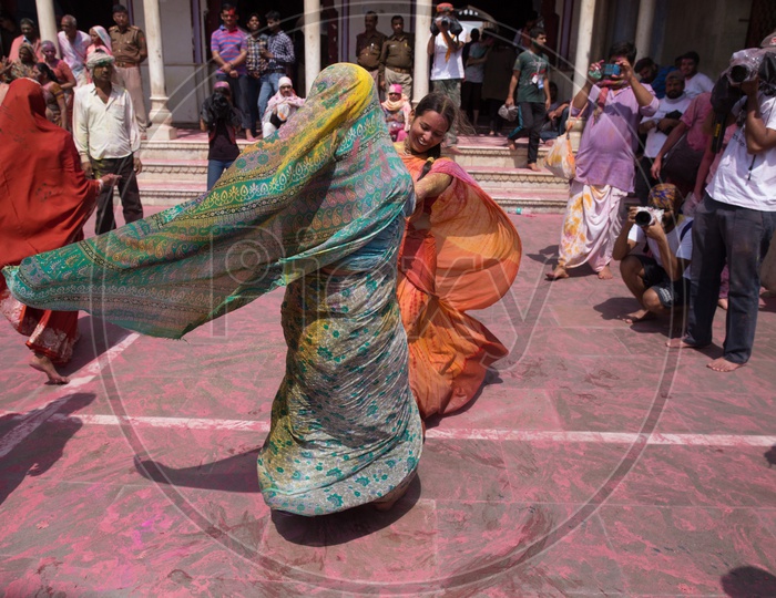Indian women in saree playing during the Holi celebrations in  Nandgaon