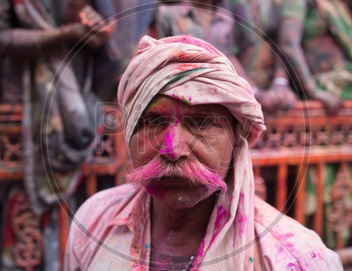 Portrait Of a Local  Man  In Barsana Filled In Holi colors With a Turban And  Mustache