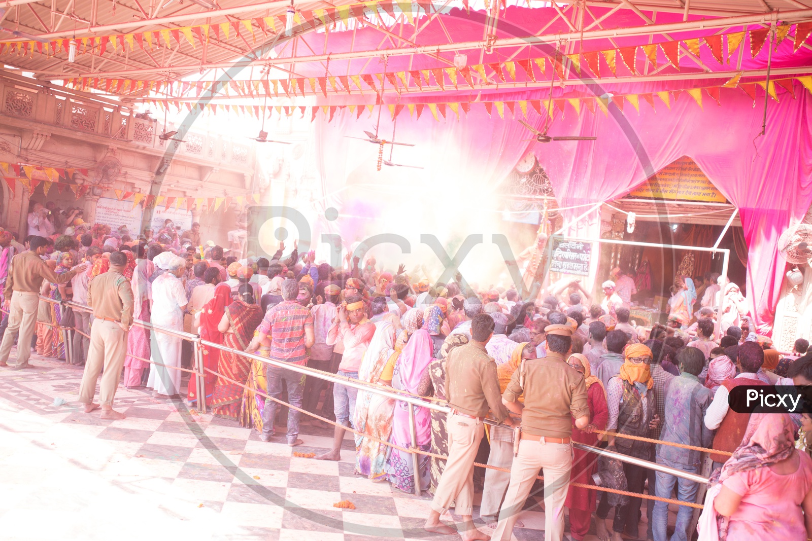 People Celebrating Lathmar Holi In Sri Radha Rani Temple Premise With Color Spalsh