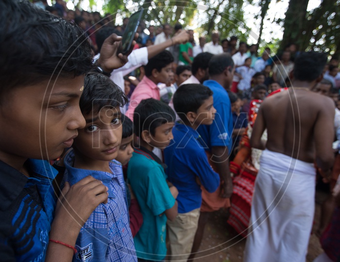 Children Watching The Theyyam  As a Crowd