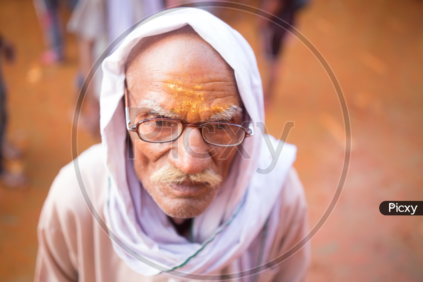 Portrait of an old man with spectacles and mustache