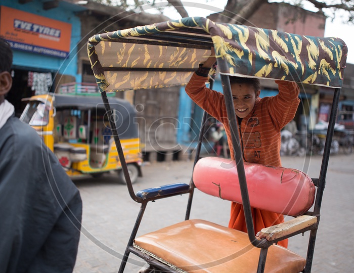 A Boy in the Rickshaw on The Streets Of Barsana