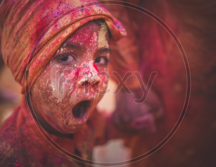 A child covered with festive Holi colors