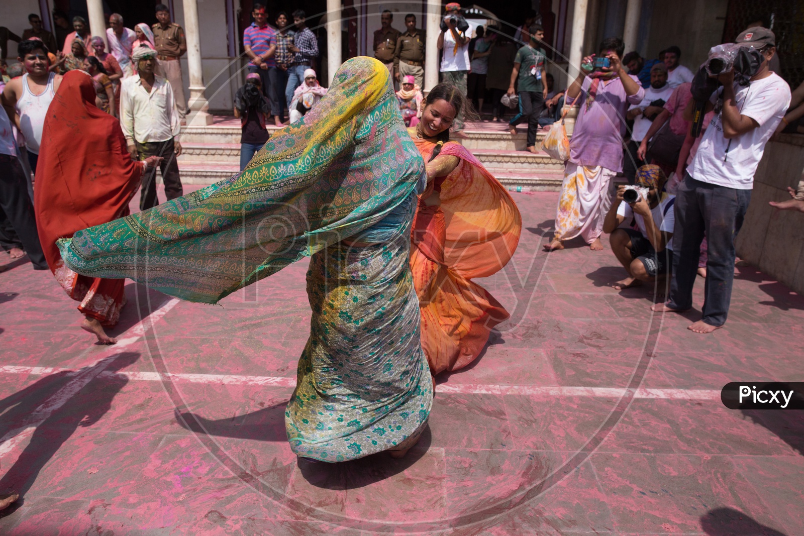 Indian women in saree playing during the Holi celebrations in  Nandgaon