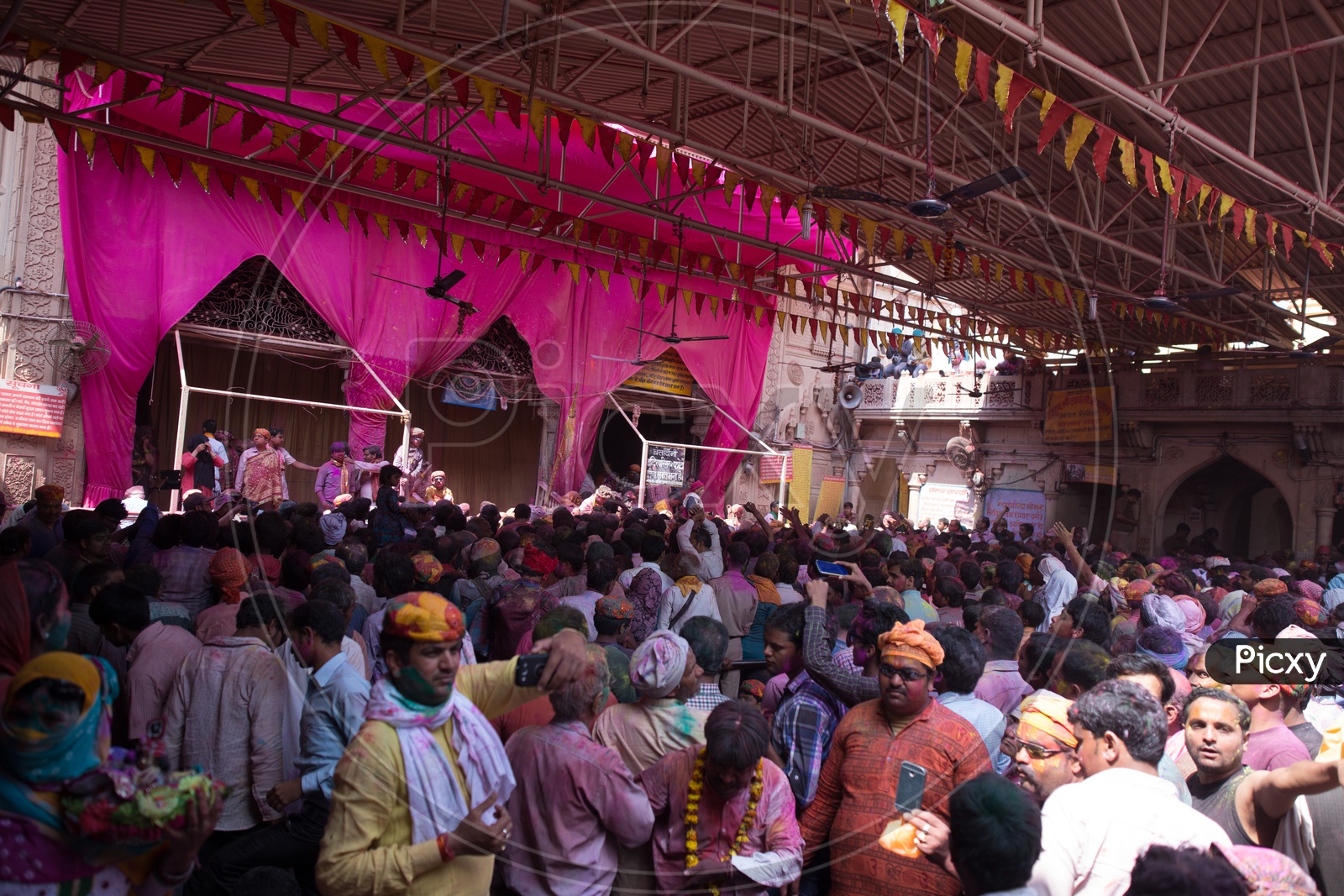 People Celebrating Lathmar Holi In Sri Radha Rani Temple Premise With Color Spalsh